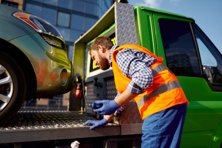 Man working in towing service on road